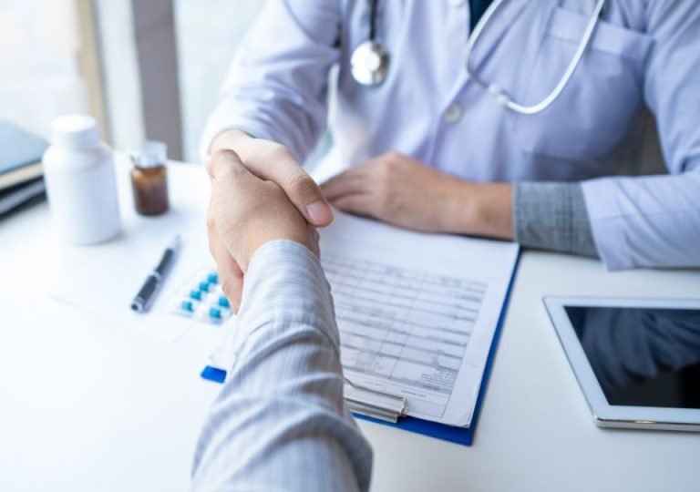 Doctor and hospital buyer shaking hands over a supply agreement