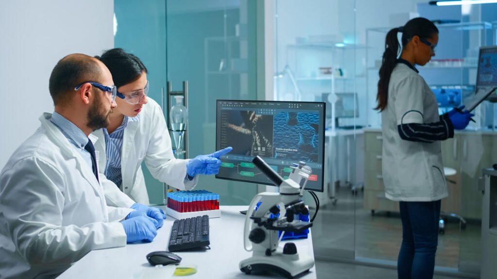 Specialist explaining an analyzer workflow to a lab colleague