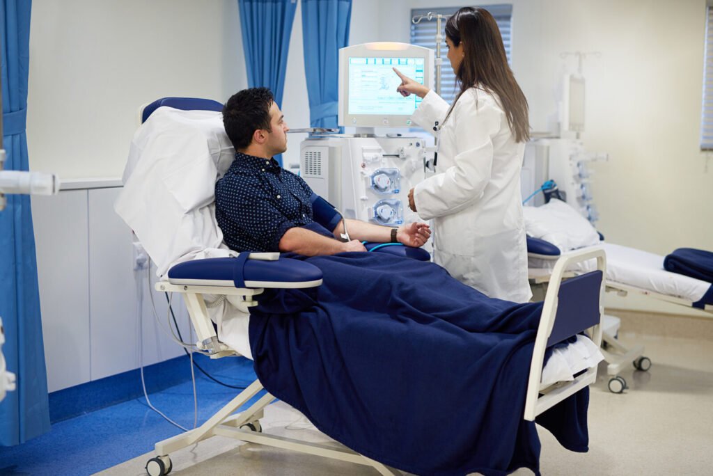 Doctor with a patient at a hospital dialysis station