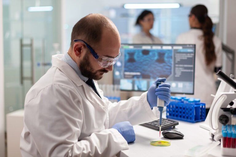 Biochemistry technician pipetting a blood sample