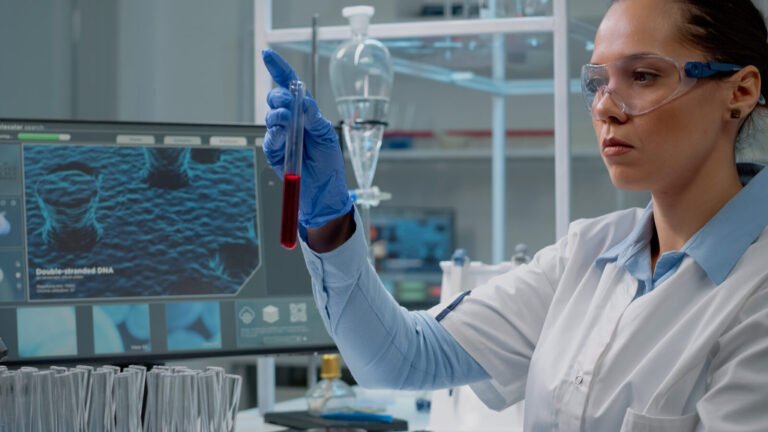 Laboratory scientist entering results on a computer