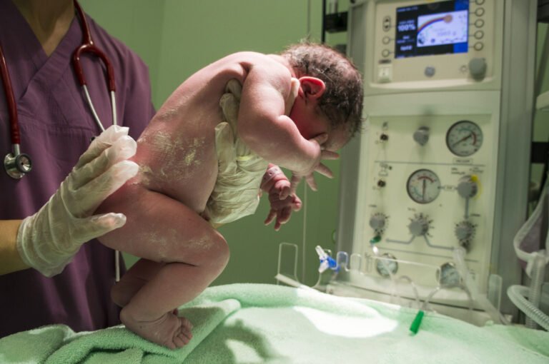 Nurse holding a newborn baby