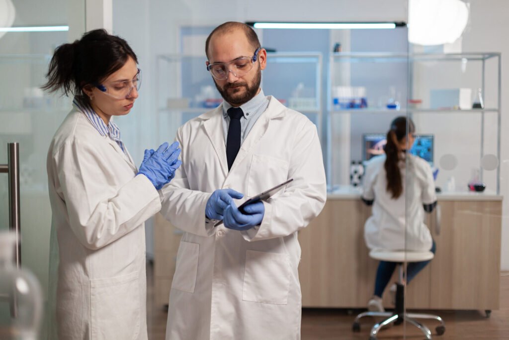 Two lab colleagues reviewing a procedure together