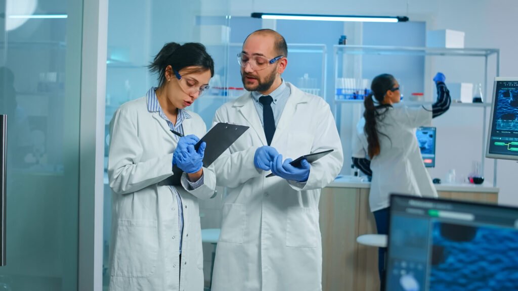 Laboratory team discussing results on a tablet beside their analyzers