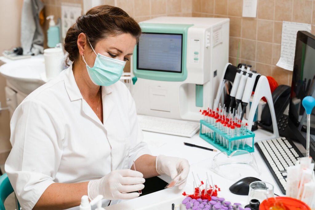 Laboratory technician running samples on a semi-automatic analyzer