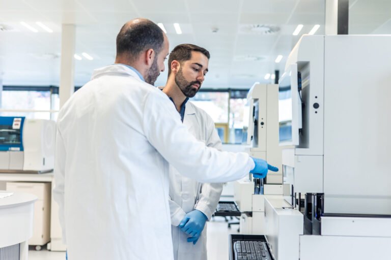 Laboratory technicians working with diagnostic analyzers