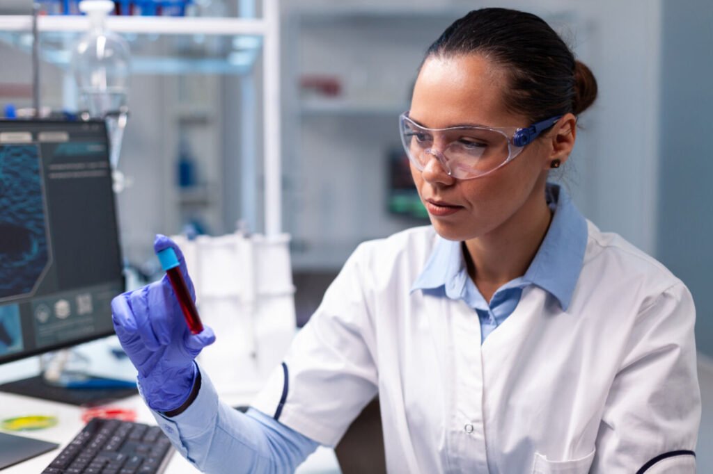 Laboratory specialist examining a blood sample tube