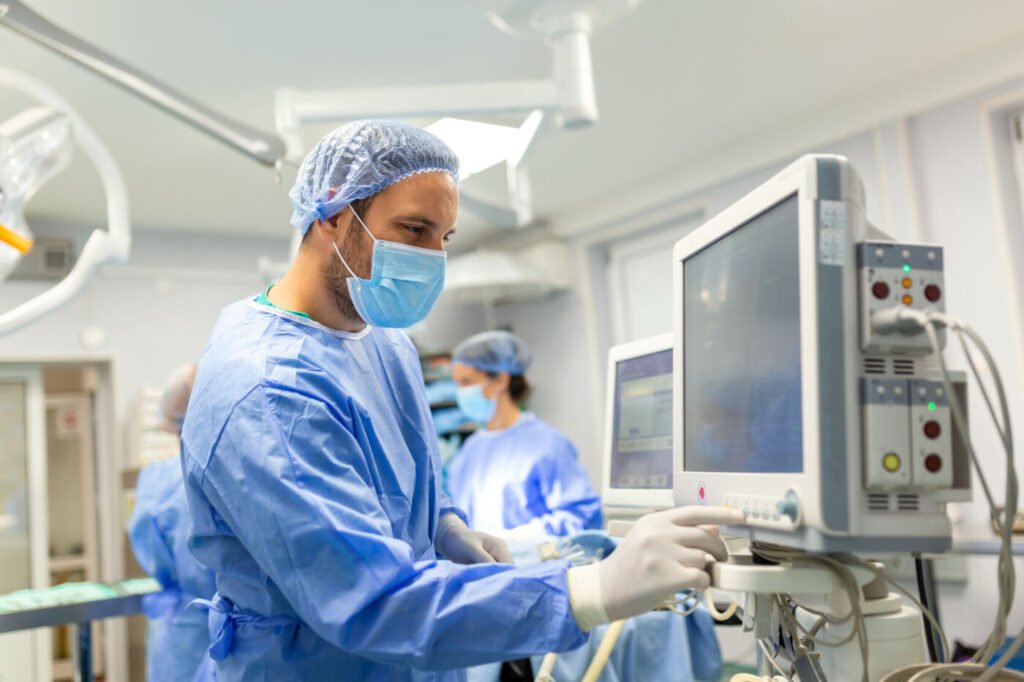 Anaesthetist checking a monitor in an operating room