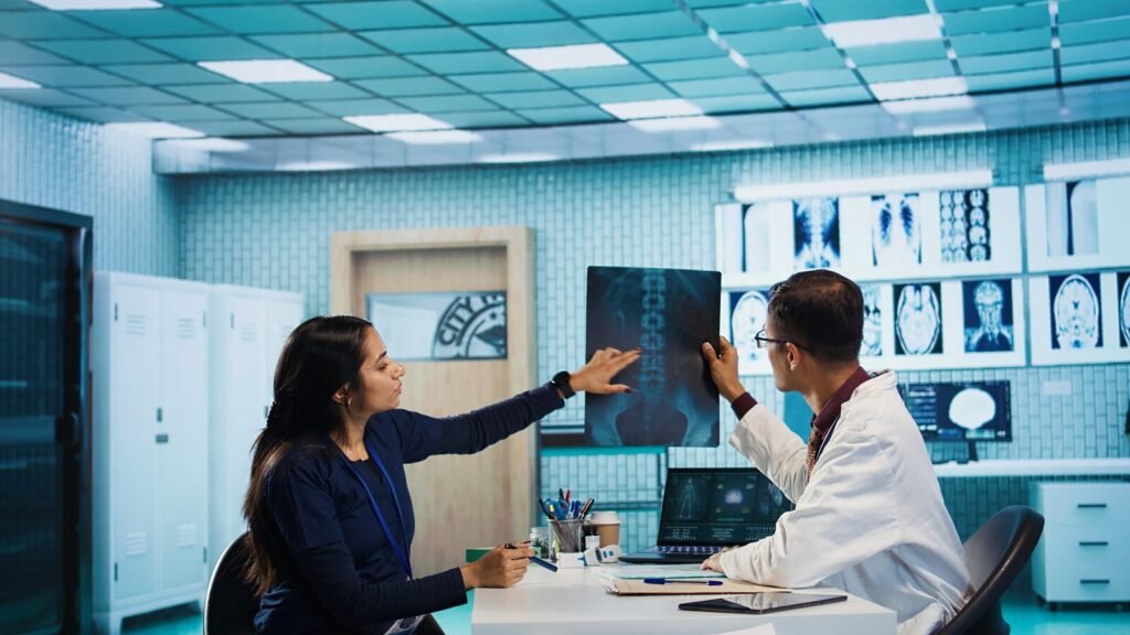 Doctor and nurse reviewing patient test reports in an Indian clinic