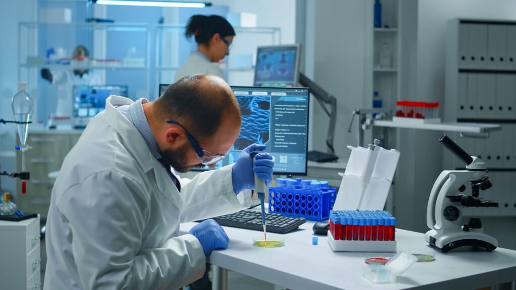 Scientist pipetting a blood sample in a laboratory