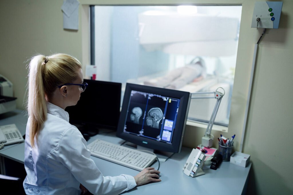 Radiologist reviewing brain imaging in a neuro control room