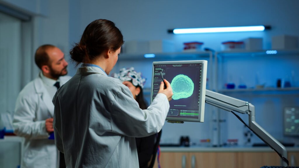 Neurology team analysing a brain scan with a patient