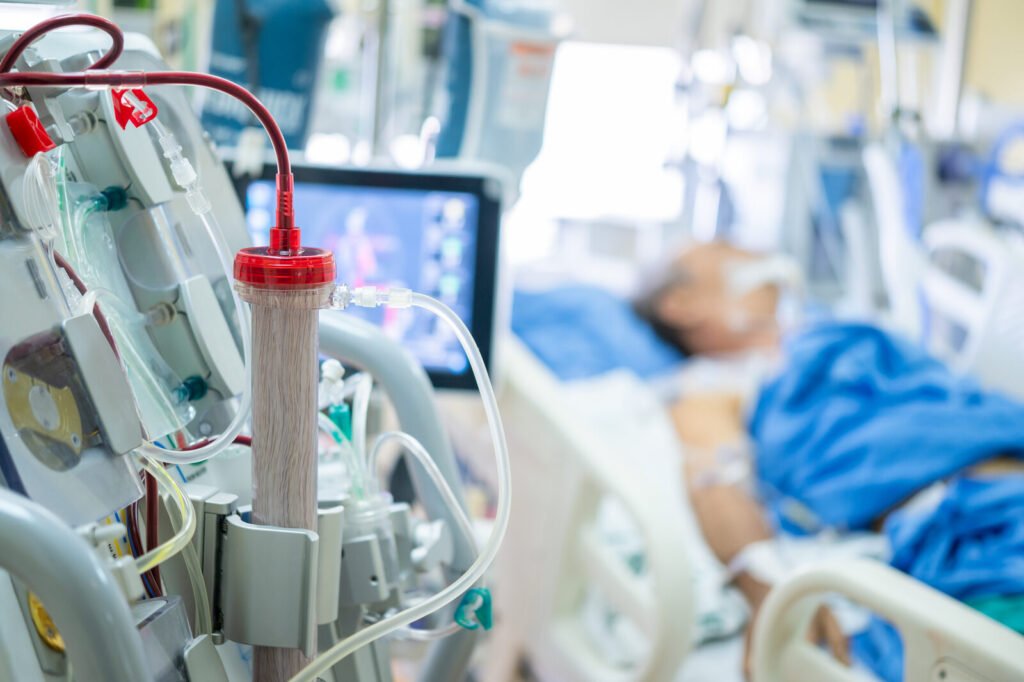 Clinicians preparing a dialysis machine for a critically ill patient