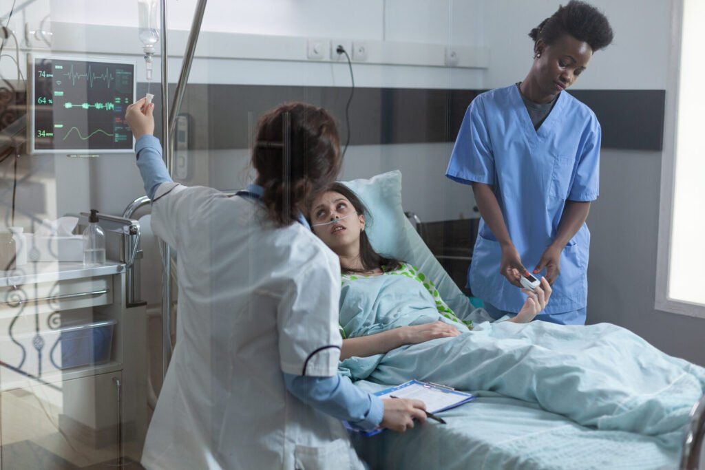 ICU doctor and nurse caring for a patient with low oxygen saturation