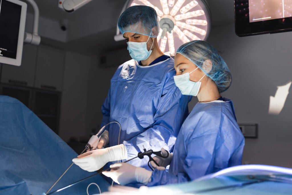 Surgeons performing laparoscopic surgery watching the monitor