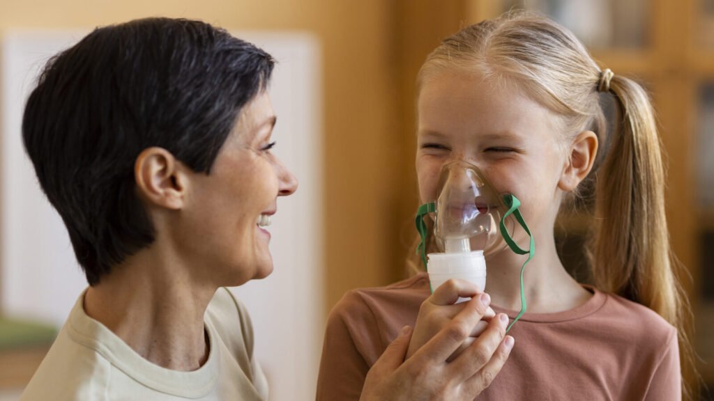 Mother helping a girl use a nebulizer