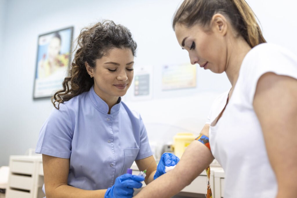 Lab technologist drawing a venous blood sample from a patient