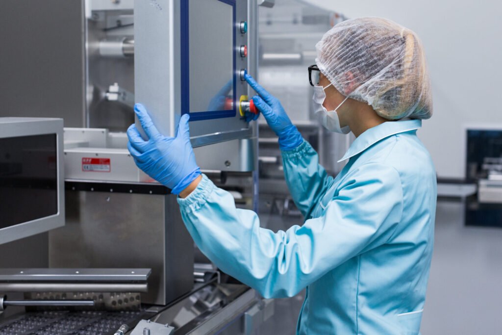 Technician operating equipment at a control panel